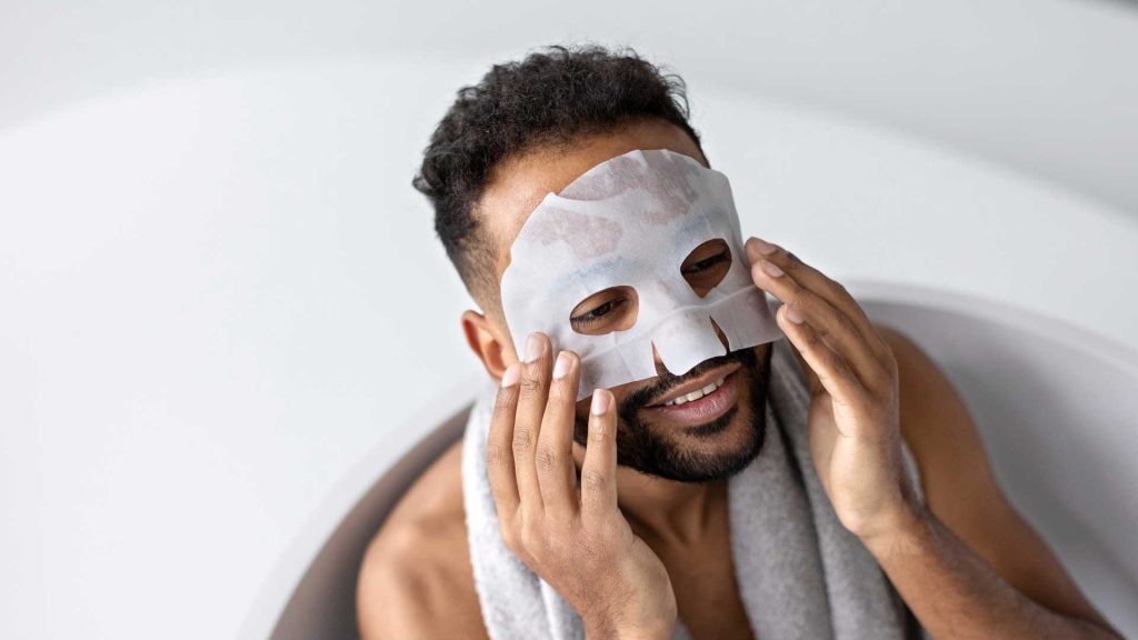 Man Applying Skin Care Face Mask